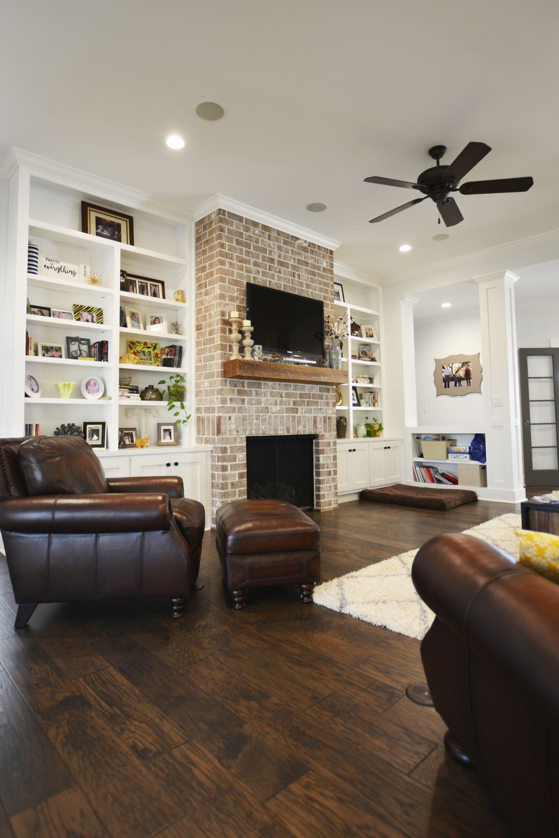 Woodbridge living room with brick fireplace